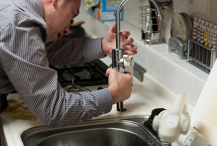 plumbers port elizabeth installing a tap in a sink